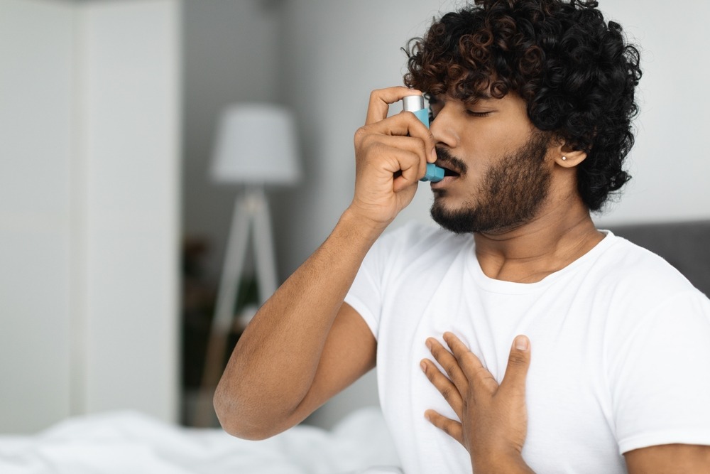 Indian,Guy,Suffering,From,Asthma,,Using,Inhaler,In,Bed,,Side